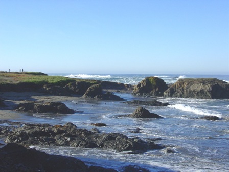 A rocky shoreline with waves crashing against the rocks