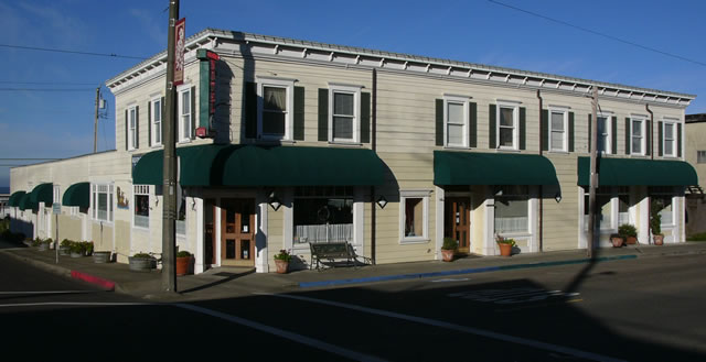 A building featuring a prominent green awning at its entrance