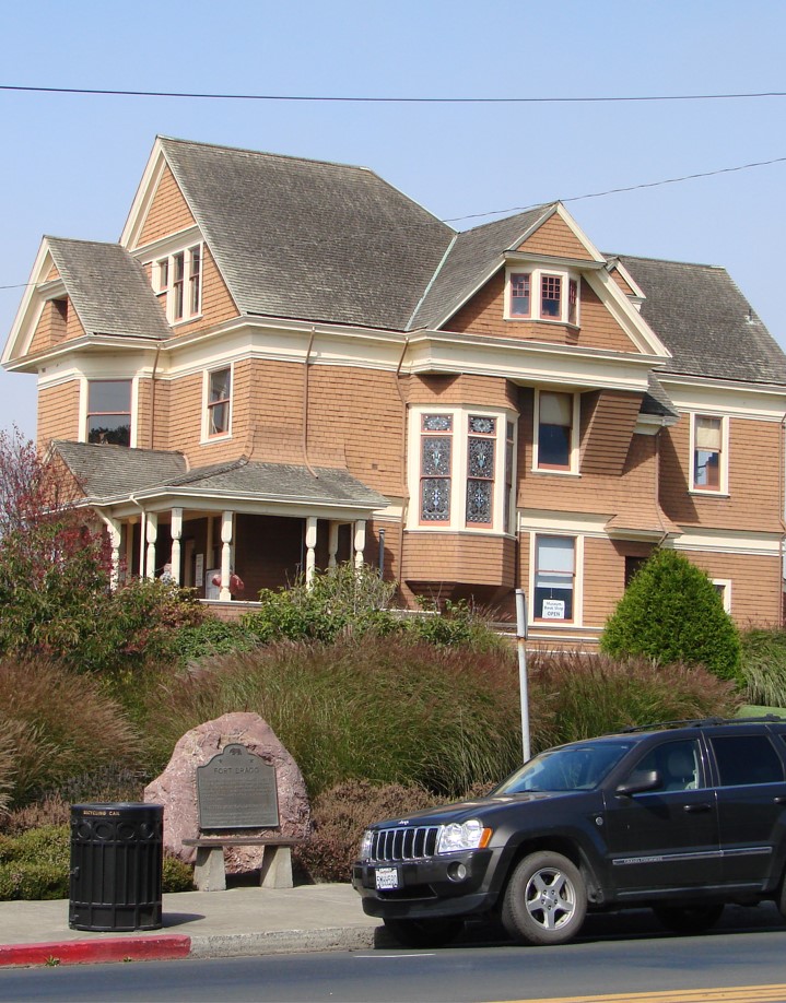 A spacious house featuring a car parked in front