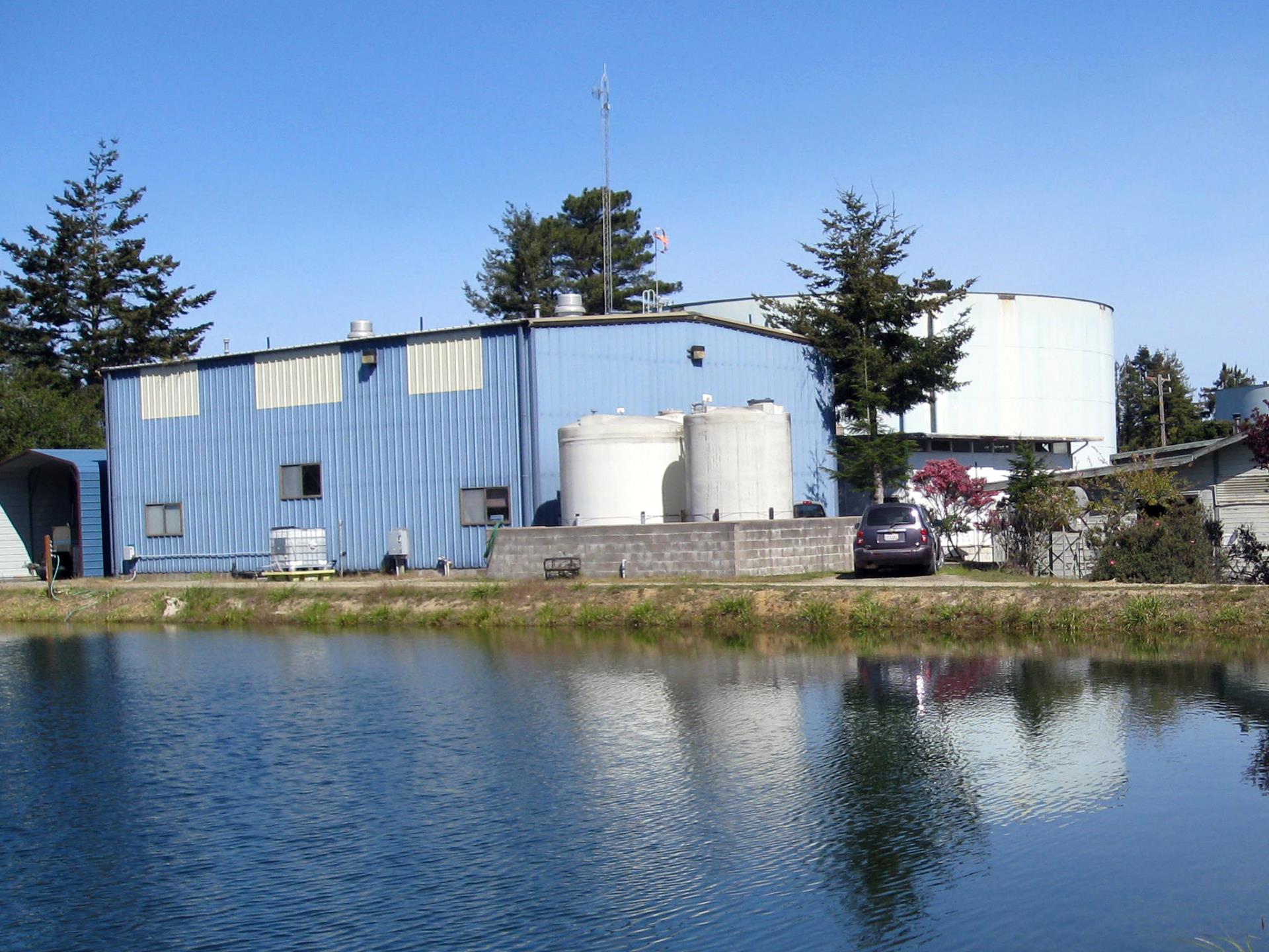 A blue building with a modern design, featuring large windows and a flat roof agai